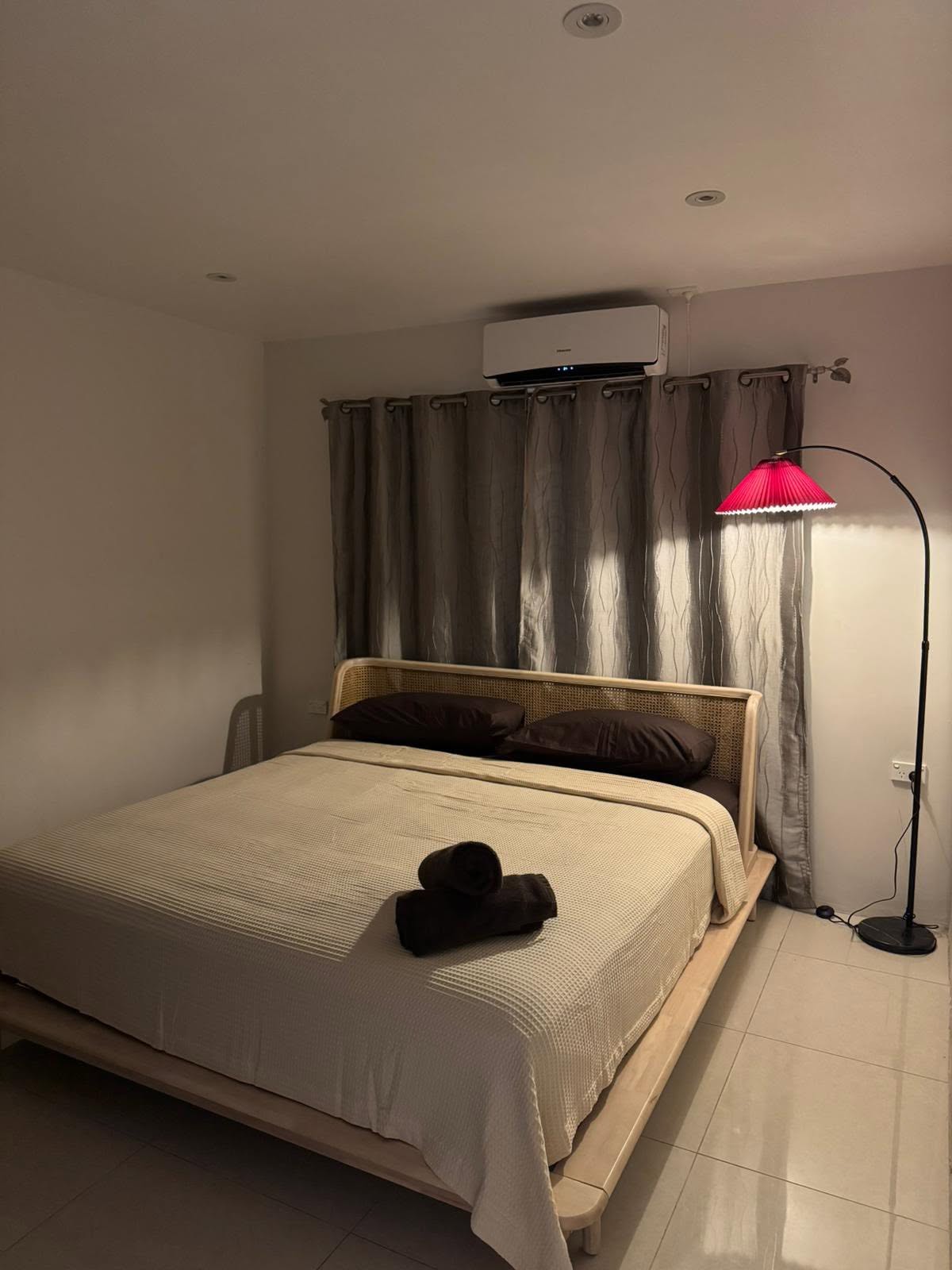 Air-conditioned Deluxe Apartment bedroom with folded towels