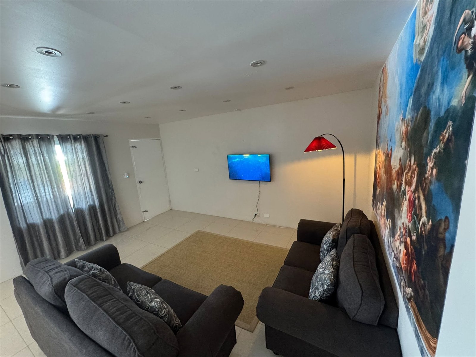 Deluxe Apartment lounge looking toward the TV and feature wall