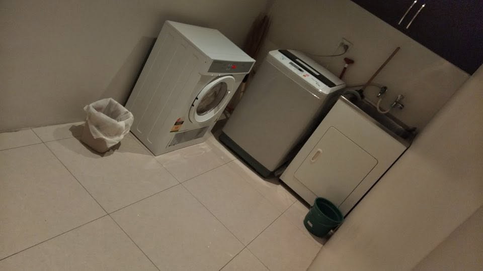Superior Apartment laundry area with washer and utility sink